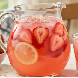 Strawberry party punch in a glass jug